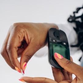 A patient checking blood glucose levels with a glucose meter