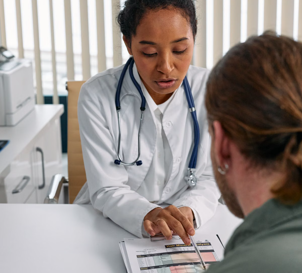 A physician reviewing a treatment plan with a patient during a chronic pain consultation